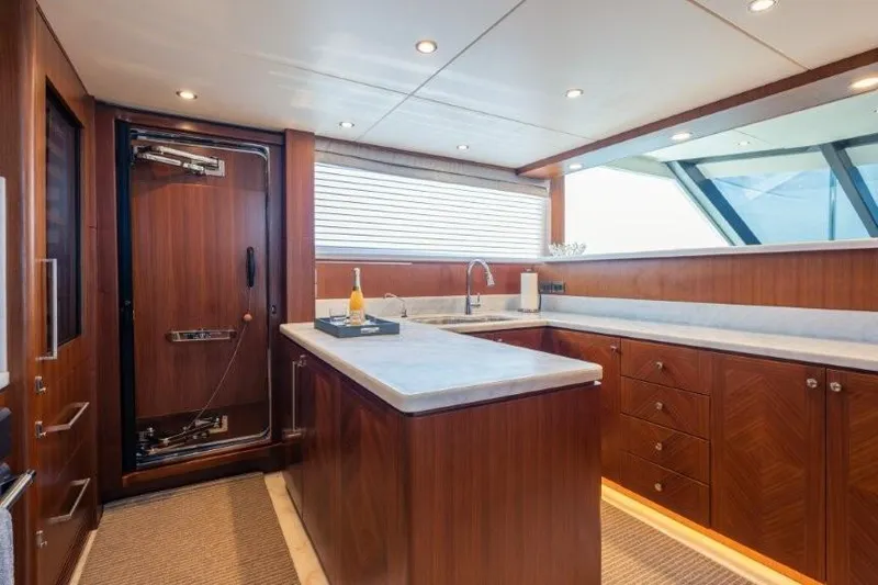 Slide: The Image of Luxurious 2017 Ocean Alexander Motor Yacht kitchen with wood cabinetry and modern fixtures. - 48
