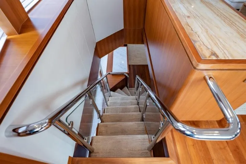 Slide: The Image of Staircase with wooden finish and metal railings inside 2017 Ocean Alexander motor yacht. - 56