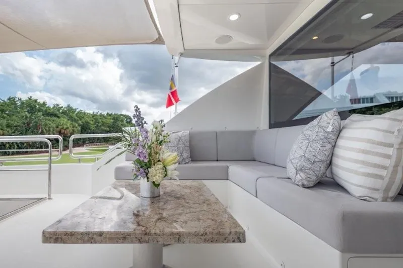 Slide: The Image of Luxurious 2017 Ocean Alexander motor yacht with elegant outdoor seating and floral centerpiece. - 57