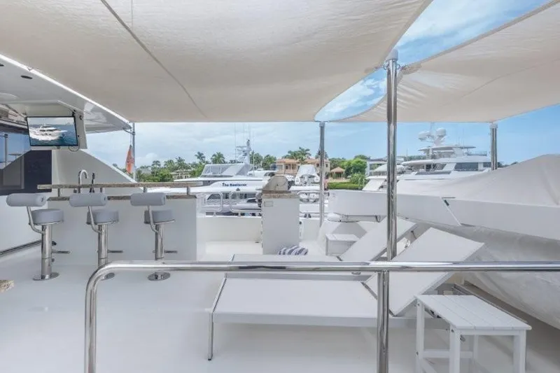 Slide: The Image of Luxurious 2017 Ocean Alexander Motor Yacht deck with bar stools and lounge chairs. - 59