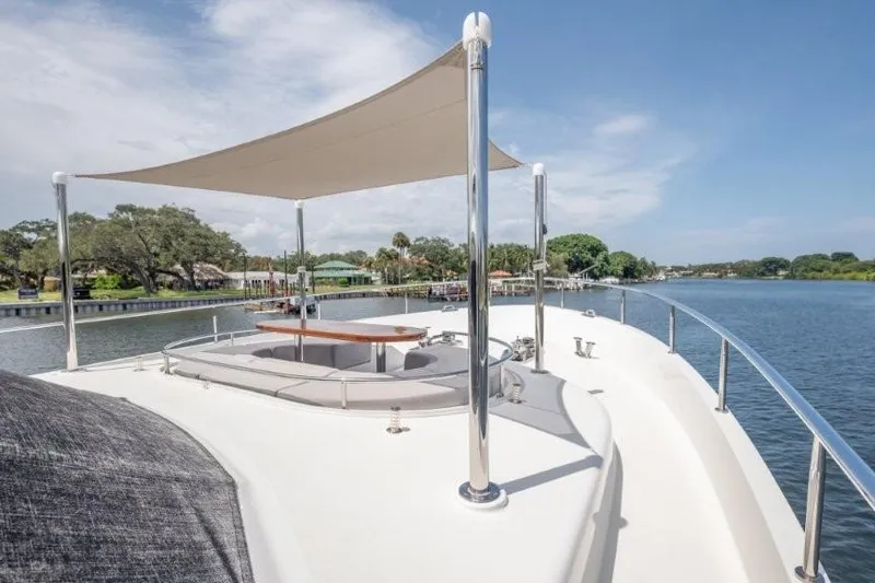 Slide: The Image of 2017 Ocean Alexander Motor Yacht deck with sunshade, cruising on a serene river. - 60