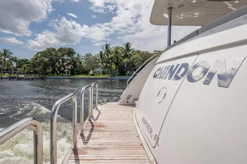 Slide: The Image of 2017 Ocean Alexander motor yacht on water, sunny day, lush greenery in background. - 66