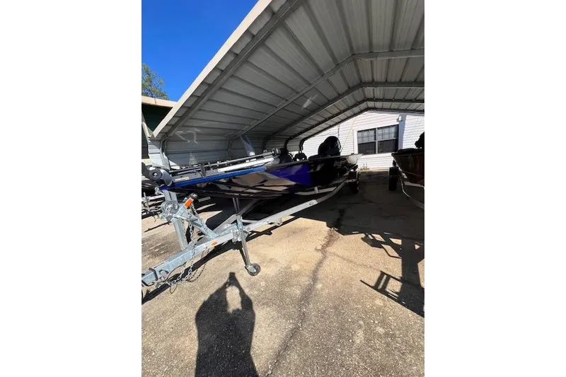 The Image of 2025 G3 Sportsman 1810 boat under metal shelter, parked on trailer. - 1