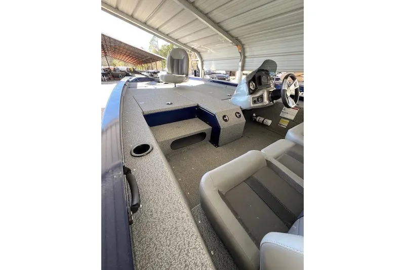 Slide: The Image of 2025 G3 Sportsman 1810 boat interior with seating and steering console under a canopy. - 3