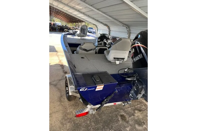 Slide: The Image of 2025 G3 Sportsman 1810 boat with Yamaha motor, parked under a metal canopy. - 7