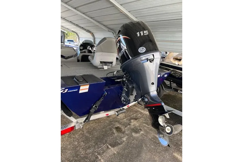 Slide: The Image of 2025 G3 Sportsman 1810 boat with 115 HP outboard motor under a metal canopy. - 8