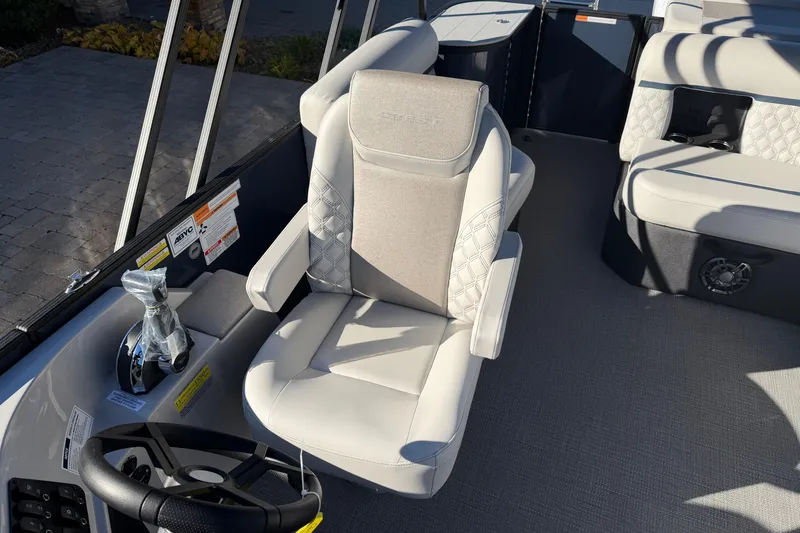 Slide: The Image of 2026 Crest Conquest 230 L boat interior with steering wheel and control panel. - 10