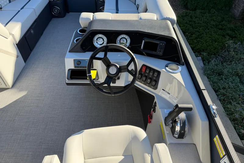 Slide: The Image of 2026 Crest Conquest 230 L boat interior with seating, table, and storage drawer. - 11