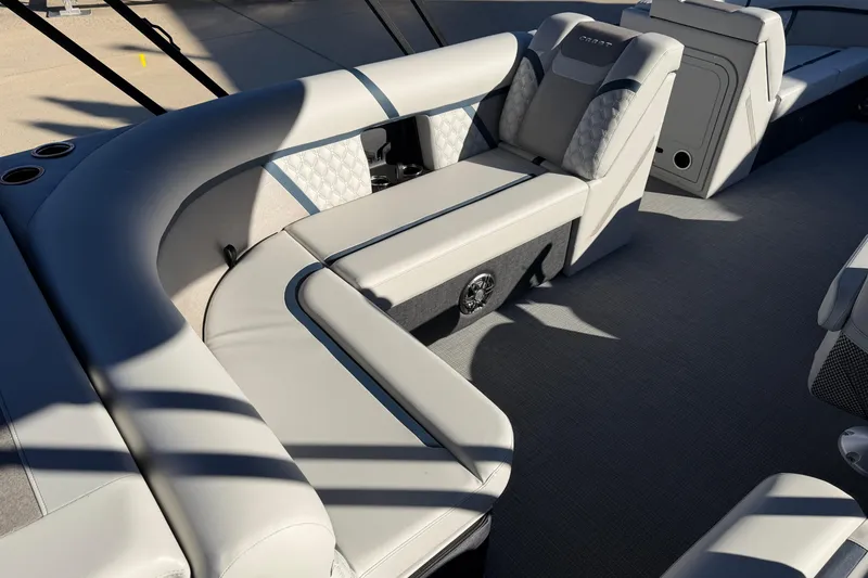 Slide: The Image of Open storage compartment in 2026 Crest Conquest 230 L boat with cushioned seating. - 17