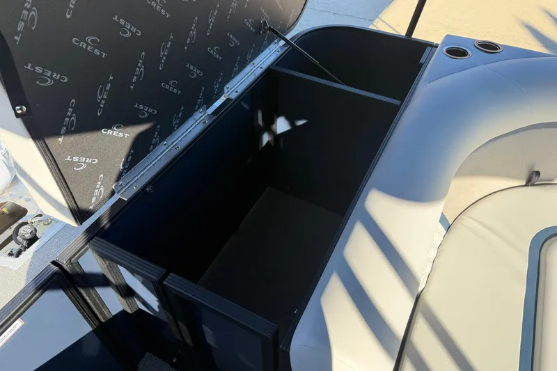 Slide: The Image of Open storage compartment on 2026 Crest Conquest 230 L boat, showcasing spacious interior. - 18