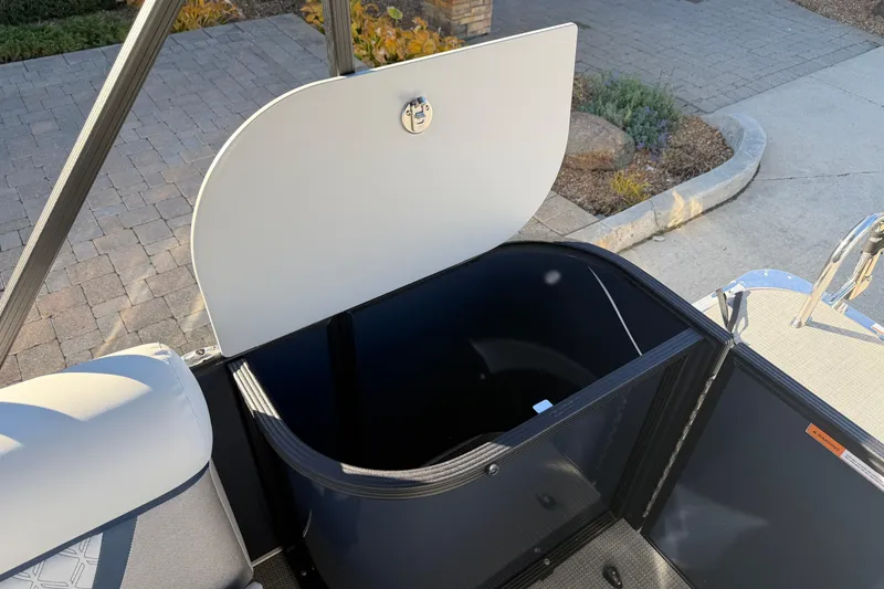 Slide: The Image of 2026 Crest Conquest 230 L pontoon boat with covered engine, parked outdoors. - 19