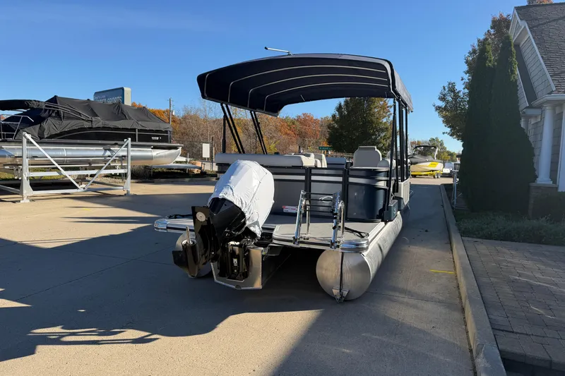 Slide: The Image of 2026 Crest Conquest 230 L pontoon boat in a garage with a navy canopy. - 20