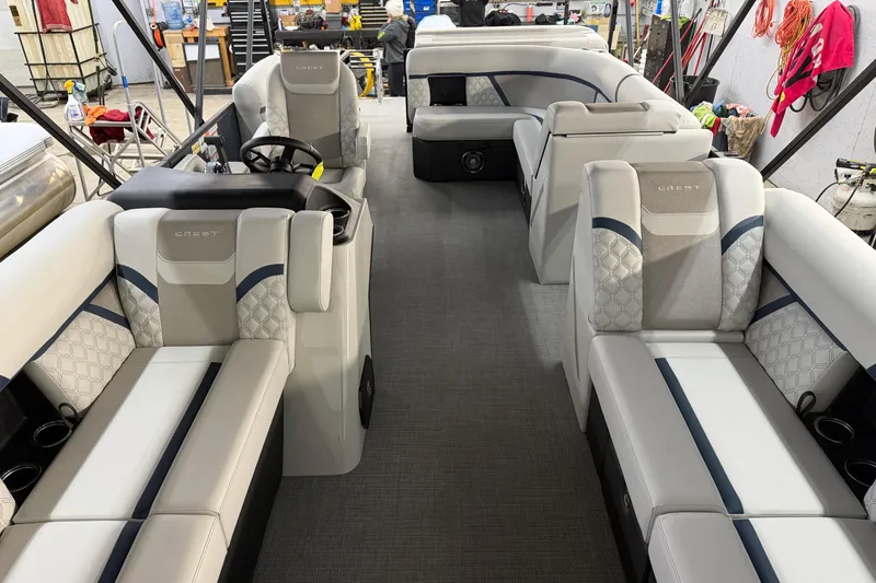 Slide: The Image of 2026 Crest Conquest 230 L boat interior with plush seating and cup holders. - 23