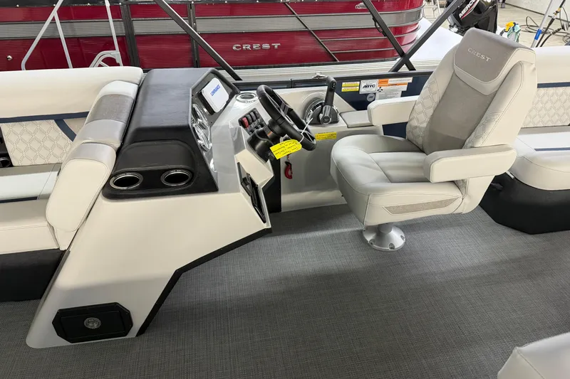 Slide: The Image of Captain's chair in 2026 Crest Conquest 230 L boat, featuring elegant upholstery and control panel. - 26