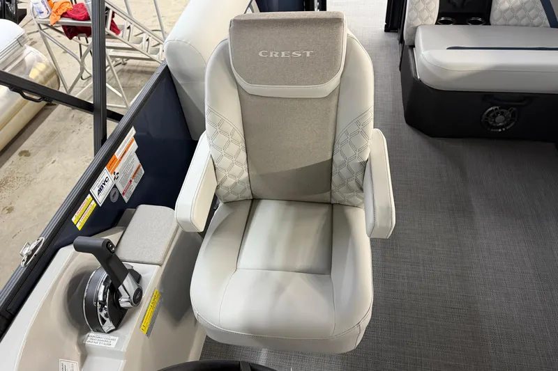 Slide: The Image of 2026 Crest Conquest 230 L boat dashboard with steering wheel and control panel. - 27