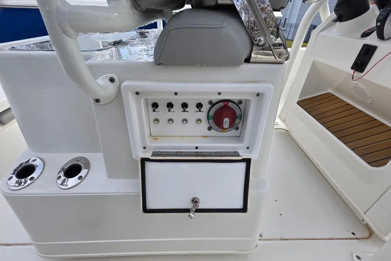 Slide: The Image of 2019 Ranger 2510 Bay Ranger boat docked near marina with other vessels. - 17