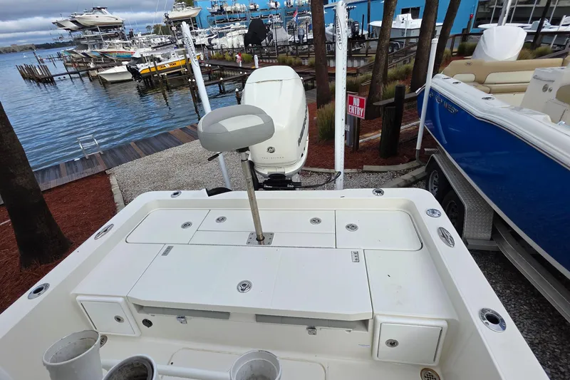 Slide: The Image of 2019 Ranger 2510 Bay Ranger boat seating area with storage and cup holders. - 19