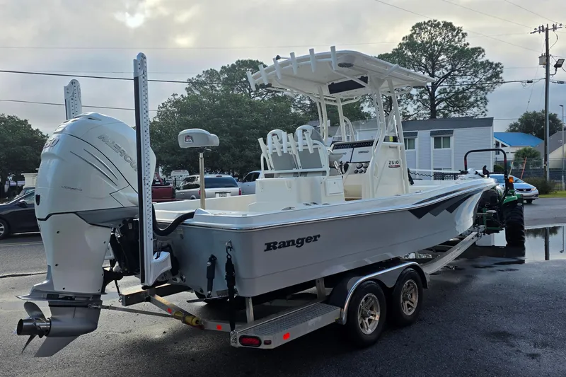 Slide: The Image of 2019 Ranger 2510 Bay Ranger boat on trailer, parked outdoors. - 2