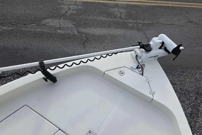 Slide: The Image of 2019 Ranger 2510 Bay Ranger boat docked at a marina, surrounded by other boats. - 8