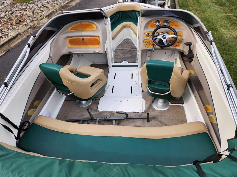 Slide: The Image of Interior of a 1998 Cobalt 200 boat with green and beige seating. - 10