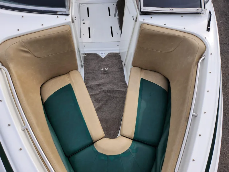 Slide: The Image of 1998 Cobalt 200 boat interior with green and beige seating. - 16