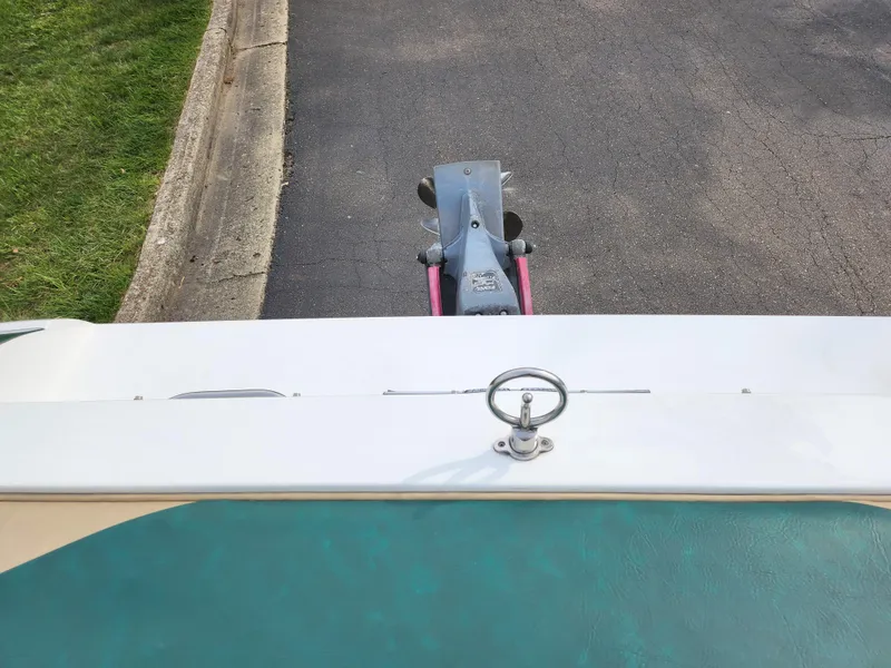Slide: The Image of 1998 Cobalt 200 boat on trailer, viewed from above, parked on asphalt near grass. - 21
