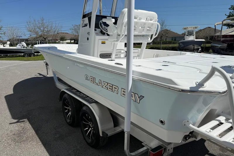 Slide: The Image of 2026 Blazer 2550 GTS boat on trailer, white exterior, parked outdoors. - 11