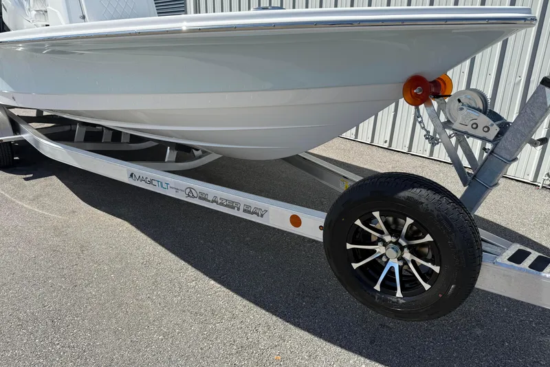 Slide: The Image of 2026 Blazer 2550 GTS boat on trailer, featuring sleek design and modern wheels. - 14
