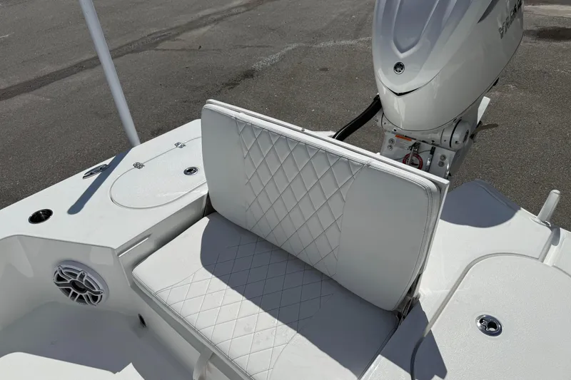 Slide: The Image of 2026 Blazer 2550 GTS boat with white quilted seating and outboard motor. - 17