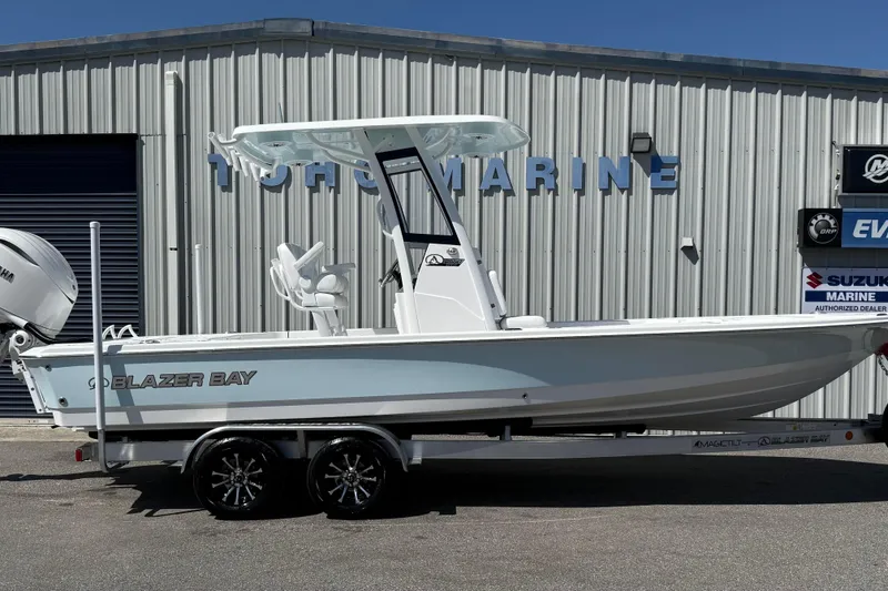 The Image of 2026 Blazer 2550 GTS boat on trailer outside marine dealership. - 2