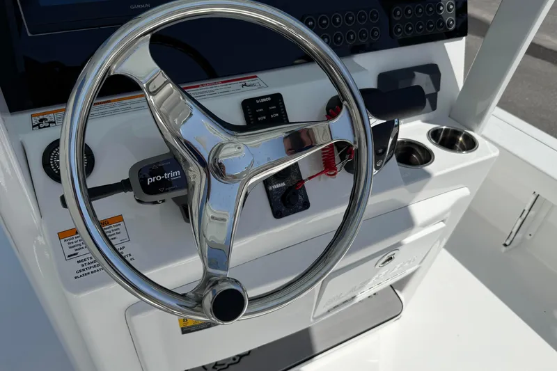 Slide: The Image of 2026 Blazer 2550 GTS boat steering console with modern controls and cup holders. - 25