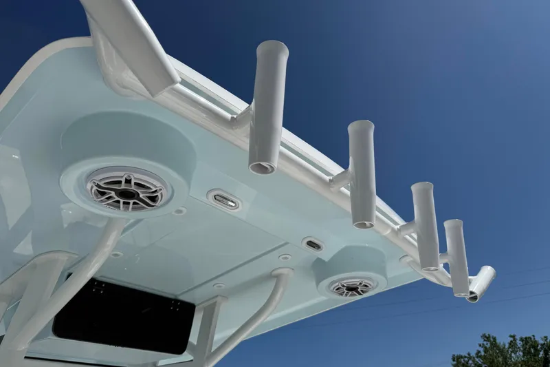 Slide: The Image of 2026 Blazer 2550 GTS boat roof with rod holders and speakers against blue sky. - 27