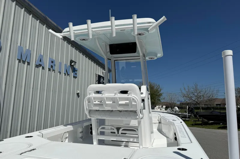 Slide: The Image of 2026 Blazer 2550 GTS boat with T-top, parked near marine building. - 40