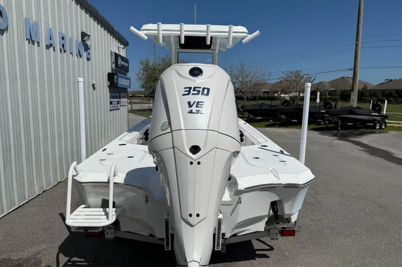 Slide: The Image of 2026 Blazer 2550 GTS boat with 350 VE 4.3L engine, parked outside a marine shop. - 8