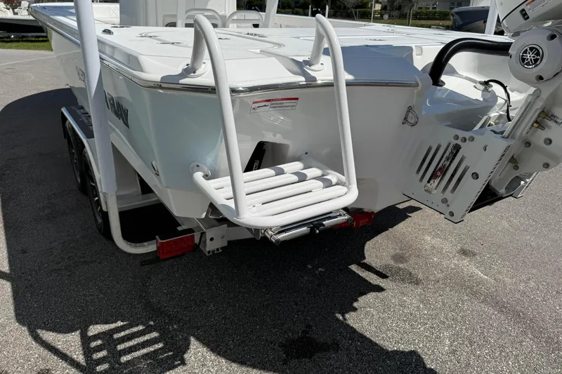 Slide: The Image of 2026 Blazer 2550 GTS boat rear view with ladder and motor on trailer. - 9