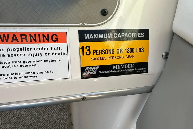 Slide: The Image of 1998 Bayliner 2659 Rendezvous capacity warning: 13 persons or 1800 lbs, 2400 lbs with gear. - 10