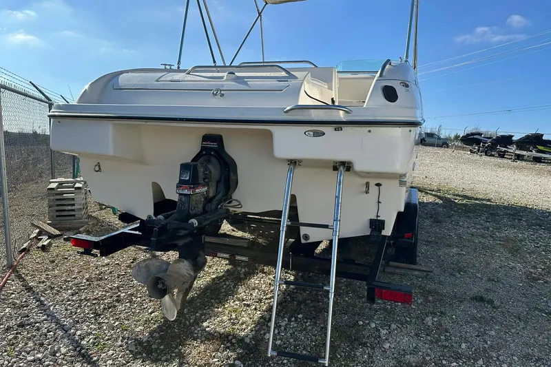 Slide: The Image of 1998 Bayliner 2659 Rendezvous boat on trailer, rear view with ladder and outboard motor. - 12