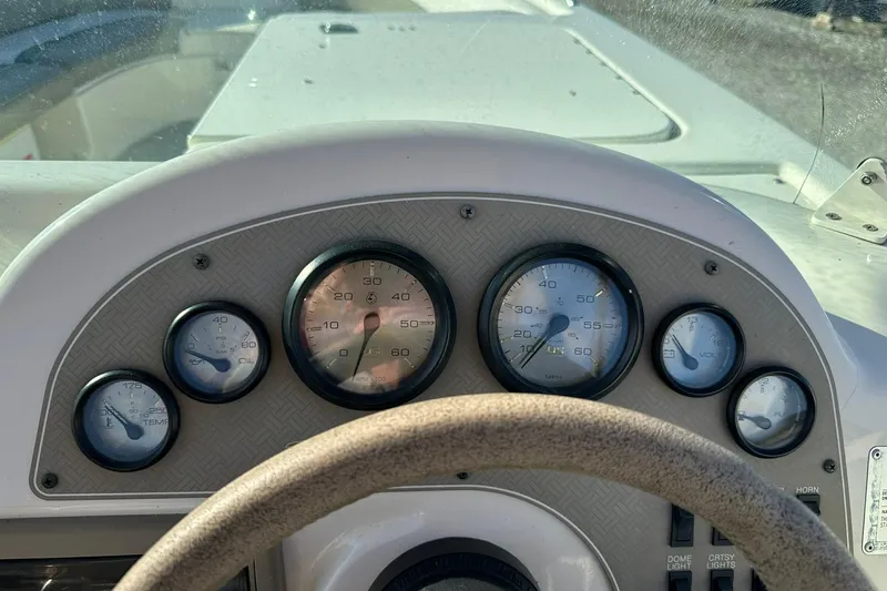 Slide: The Image of Dashboard of a 1998 Bayliner 2659 Rendezvous boat with gauges and steering wheel. - 18