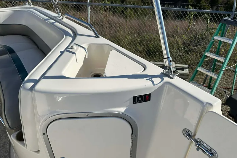 Slide: The Image of 1998 Bayliner 2659 Rendezvous boat interior with seating and storage compartment. - 6