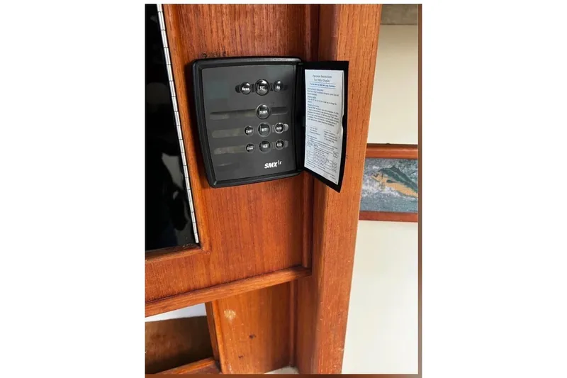 Slide: The Image of Control panel on a 2005 Carolina Classic 28 boat, mounted on wooden surface. - 10