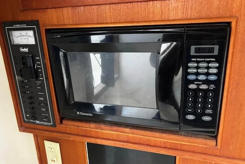 Slide: The Image of Microwave and control panel in 2005 Carolina Classic 28 boat interior. - 11