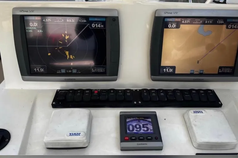 Slide: The Image of Control panel of a 2005 Carolina Classic 28 boat with Garmin GPS displays. - 6