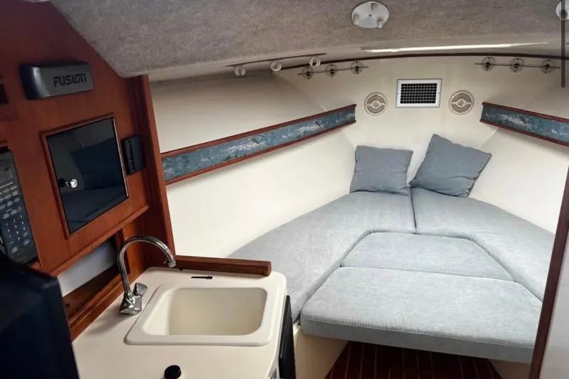 Slide: The Image of Interior of 2005 Carolina Classic 28 boat with cozy cabin and sink. - 8