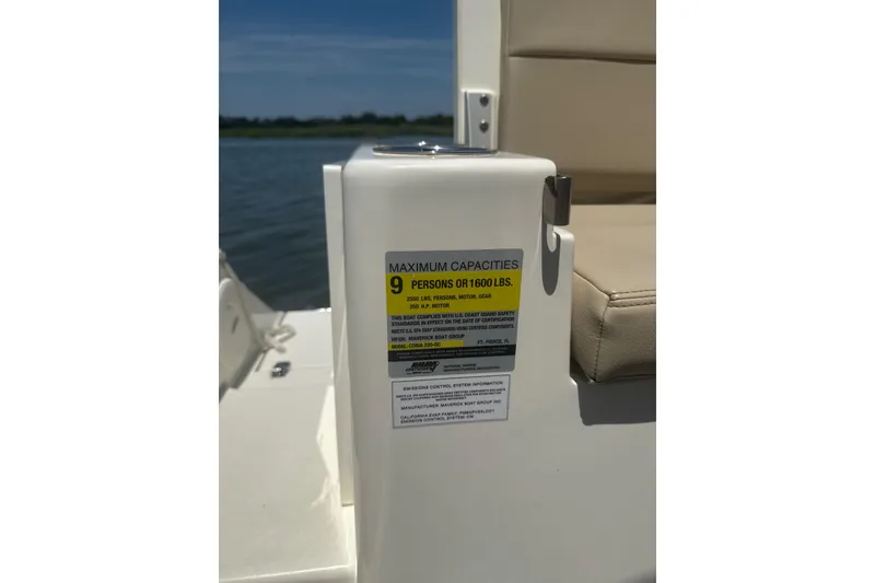 Slide: The Image of 2024 Cobia 220 Dual Console boat capacity label, maximum 9 persons or 1600 lbs. - 12