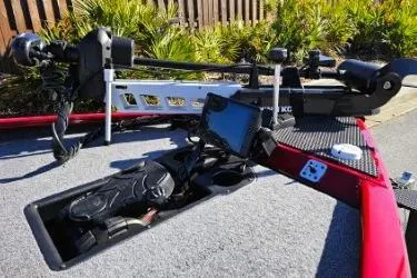 Slide: The Image of 2025 Tracker Savage 215 boat with powerful outboard motor, parked on a trailer. - 2