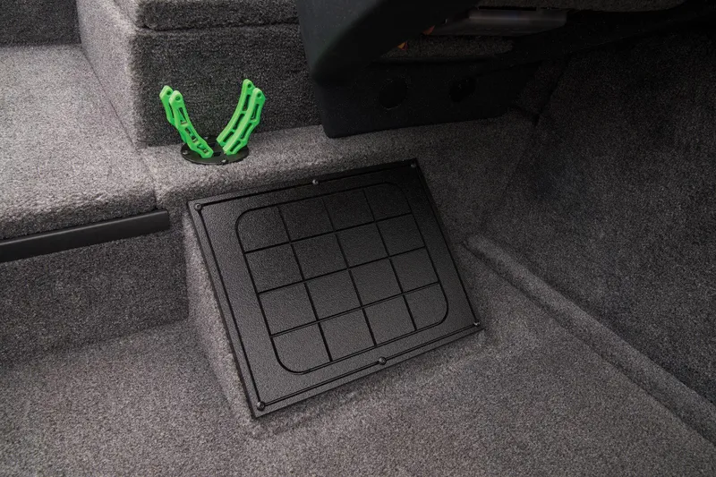 Slide: The Image of Manufacturer Provided Image: Interior of 2025 Tracker Savage 215 boat with storage compartment and green accessory. - 28