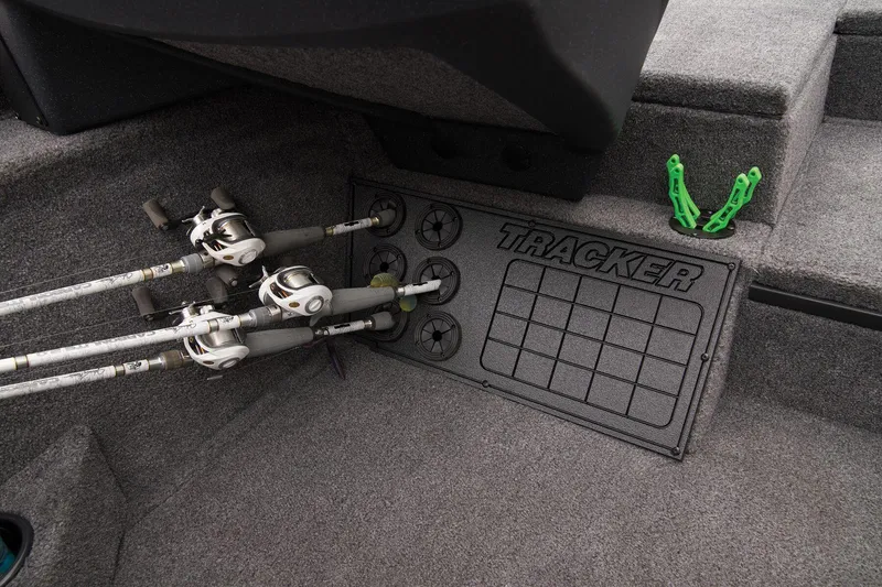 Slide: The Image of Manufacturer Provided Image: 2025 Tracker Savage 215 boat interior with fishing rods and storage compartment. - 32