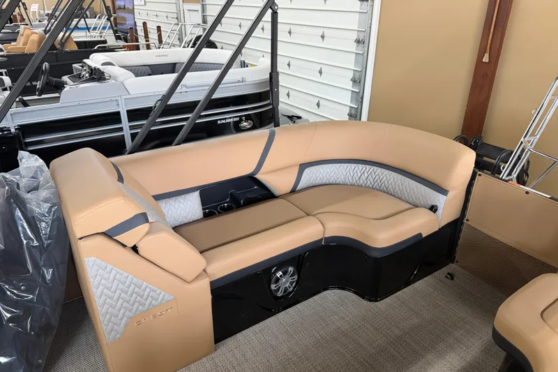 Slide: The Image of 2026 Crest Caribbean 230 SLC boat interior with tan seating and modern design. - 5