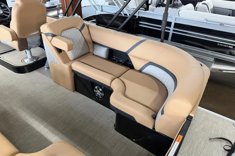 Slide: The Image of Luxurious seating on 2026 Crest Caribbean 230 SLC pontoon boat, featuring tan upholstery and modern design. - 6