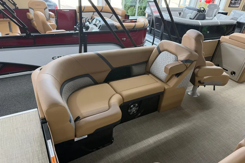 Slide: The Image of 2026 Crest Caribbean 230 SLC boat interior with luxurious tan seating and modern design. - 7